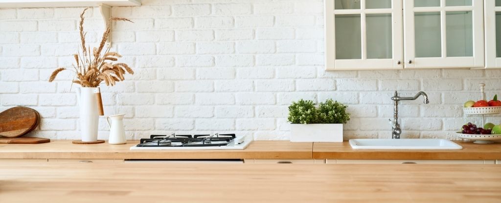 A cheerful kitchen with light brown wood countertops